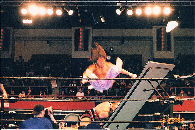 ECW became known for its hardcore style, frequently incorporating weapons into matches. Sabu (putting Rhino through a table in this picture) especiall