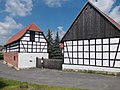 Residential house, two side buildings and barn of a four-sided courtyard