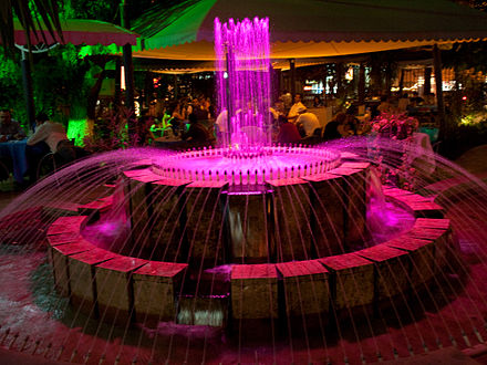 Outdoor cafe with a colour-changing fountain.
