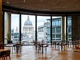 A dining space, with large floor-to-ceiling windows and a view of St. Paul's Cathedral