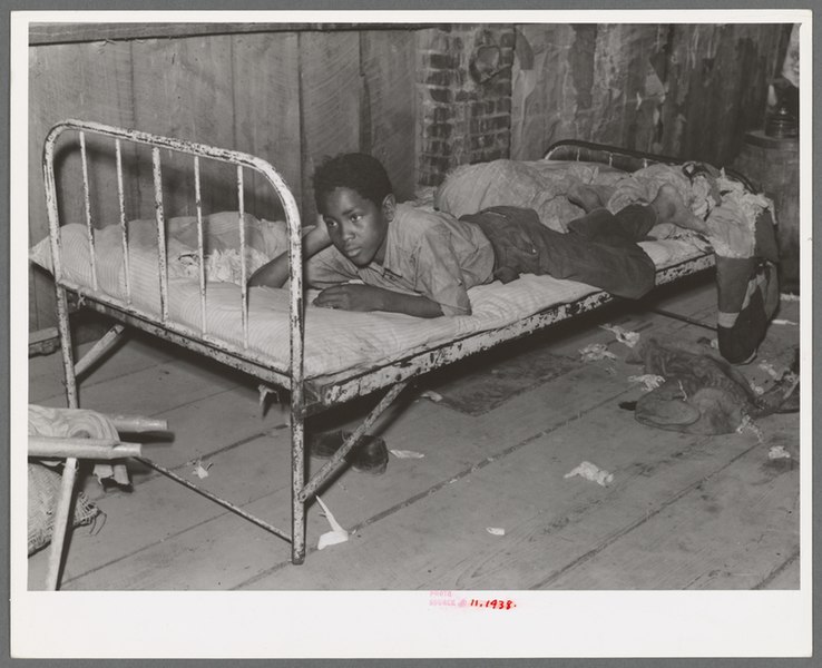 File:Boy resting on bed in attic of sharecropper shack, New Madrid County, Missouri.jpg