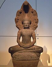 Meditating Buddha being shielded by the naga Mucalinda. Cambodia, 1150 to 1175 Buddha shielded by Naga.jpg