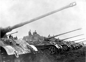 Konigstiger with a Henschel turret in formation. During the Nazi era, heavy industry was increasingly restructured in order to mass-produce weapons of war such as this. Bundesarchiv Bild 146-1975-102-14A, Panzer VI (Tiger II, Konigstiger).jpg