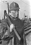 A brown coal miner with a pickaxe. West Germany, 1952