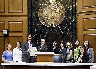 Representative Saunders presents the Concurrent Resolution to instructor Richard McCoy and students of the IUPUI Museums Studies Program CCMResolution.jpg