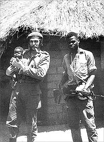 37-year-old Guevara, holding a Congolese baby and standing with a fellow Afro-Cuban soldier in the Congo Crisis, 1965
