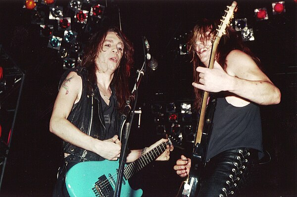 Guitarists Scotti Hill and Dave "Snake" Sabo performing with the band in 1989