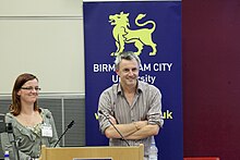 Guy Holmes and Nicki Evans, 1st International Conference on the Multi-Dimensions of Well-Being, Birmingham, 2011 Guy Holmes and Nicki Evans, 1st International Conference on the Multi-Dimensions of Well-Being, Birmingham, 2011.jpg