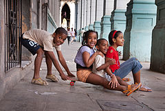 Childrten having fun with a skateboard by the "Recovas". Havana (La Habana), Cuba