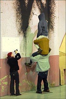 Woman photographing a Barry McGee installation, Xe Biennale de Lyon Installation (Xe Biennale de Lyon) (4104042716).jpg