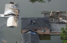 People on the roofs of their houses avoiding the flood after Hurricane Katrina Katrina-14512.jpg