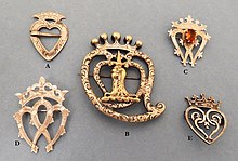 Examples of Luckenbooth brooches with varying decorative styles Luckenbooth brooches .jpg