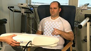 Seated patient preparing for chest SLP scan Male Patient SLP.jpg