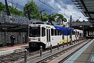 An overhauled Type 1 in the third TriMet paint scheme. Most Type 1 cars now look like this. Mixed-consist MAX train arriving at Sunset TC in 2012.jpg