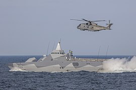 HSwMS Karlstad with British Merlin helicopter during BALTOPS 20