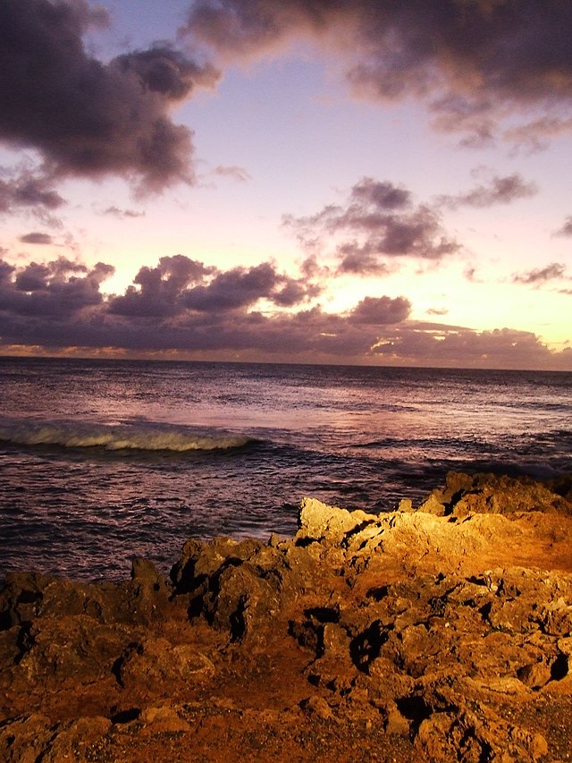 Lava rock strewn beach at sunset on Turtle Bay