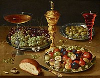 Still life with a hanap, dish of grapes, bowl of fruit, olives, bread and glass of wine, 1610s