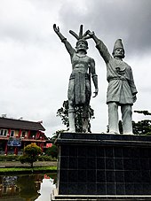 The "Dayak-Malay" brotherhood monument in West Kalimantan Provincial Museum, Pontianak, Indonesia. Forming 34.93% and 33.84% respectively, the Dayak and the Malays are the two largest native indigenous communities in the province. Patung Dayak Melayu.jpg
