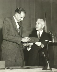 AEC chair John A. McCone presents the Enrico Fermi Award to Glenn T. Seaborg in 1959. Seaborg succeeded McCone as AEC chair in 1961.