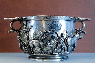 A skyphos is a two-handled deep wine-cup on a low flanged base or none. The handles may be horizontal ear-shaped thumbholds that project from the rim, or they may be loop handles at the rim or that stand away from the lower part of the body. Skyphoi of the type called  glaux (owl) have one horizontal and one vertical thumbhold handle.
