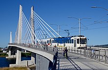 TriMet's Tilikum Crossing, built as part of the MAX Orange Line project, opened in 2015. Tilikum Crossing from north sidewalk with MAX train 2016.jpg