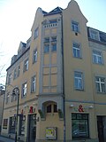 Apartment building in a corner and open development