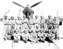 Official US Army Air Force Training Command photograph of 20 Tuskegee Airmen posing in front of a P-40 at Tuskegee Army Air Field Tuskegee Army Airfield - 1.jpg