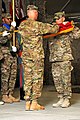 U.S. Army Maj. Gen. James L. Terry and Command Sgt. Maj. Christopher K. Greca, 10th Mountain Division (LI) commander and command sergeant major, roll up the division flag during a transfer of authority ceremony 111001-A-EK646-002.jpg