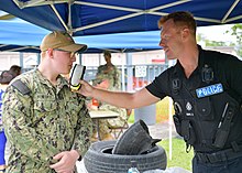 A ROPO 3 of the Royal Navy Police administers a breathalyzer to a U.S. Navy yeoman stationed on Diego Garcia. USN with ROPO.jpg