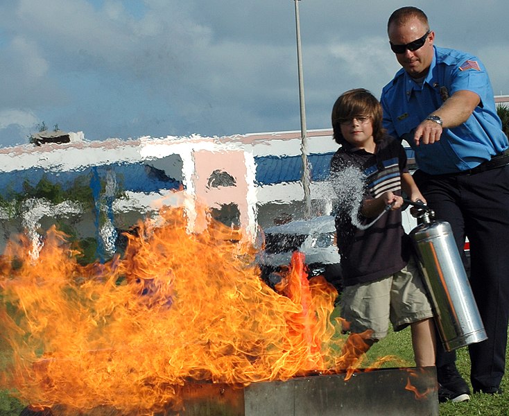 File:US Navy 081008-N-0311M-156 Richard Niles, a Naval Air Station Key West firefighter, teaches a boy how to properly use a fire extinguisher during an annual Fire Safety Fair at Sigsbee Park, Fla.jpg