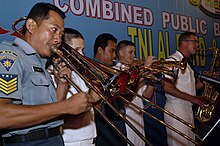 Indonesian Navy musicians play alongside US Navy musicians US Navy 090826-M-8539M-054 The brass section of the Indonesian TNI Navy Band joins the U.S. 7th Fleet Rock Band, Orient Express, during a joint concert at Artha Gading Mall.jpg