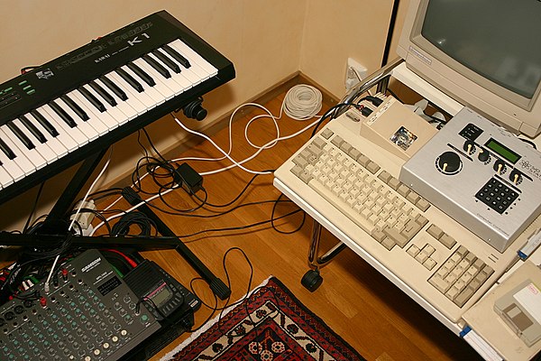 A minimal bedroom studio set-up with 1980s–1990s equipment