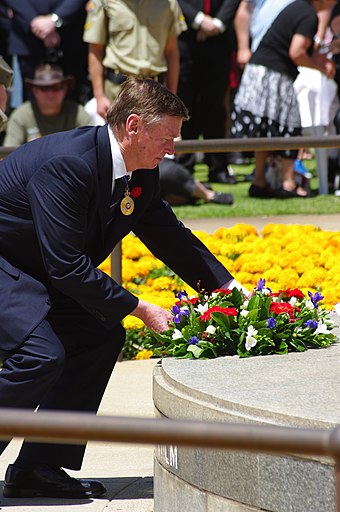 The Governor of Western Australia, Malcolm McCusker, laying a wreath at the Eternal flame, Kings Park, Western Australia, 11 November 2011
