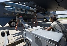 Members of the Global Strike Challenge nuclear/conventional load crew team lift a GBU-31 Joint Direct Attack Munition into position during a dry run leading up to the 2012 Air Force Global Strike Command Challenge on Barksdale Air Force Base, La., Aug. 20, 2012. A striking challenge (7851986672).jpg