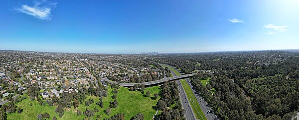 Aerial panorama of the Eastern Freeway section in Balwyn North facing the city skyline. September 2023.