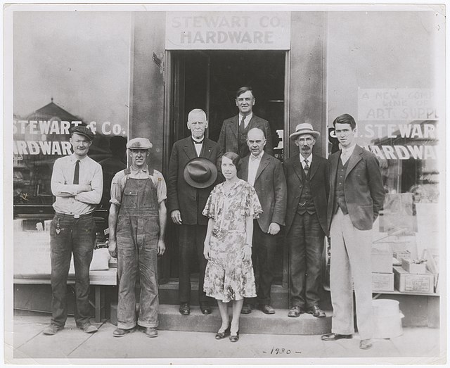 Stewart (right) outside his family's hardware store, 1930