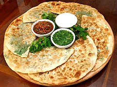 Bolani (a stuffed flatbread) with condiments