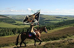 The defaced Saltire of the Royal Burgh of Selkirk leading the Common Riding.