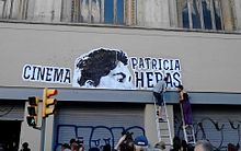 Activists paste up the new name of Cinema Patricia Heras on a squatted cinema in 2013 Cinema Patricia Heras.jpg