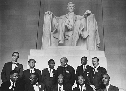 Leaders of the March on Washington photographed in front of the statue of Abraham Lincoln on August 28, 1963: (sitting L-R) Whitney Young, Cleveland Robinson, A. Philip Randolph, Martin Luther King Jr., and Roy Wilkins; (standing L-R) Mathew Ahmann, Joachim Prinz, John Lewis, Eugene Carson Blake, Floyd McKissick, and Walter Reuther