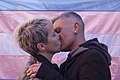 Couple kissing in front of transgender flag (42997071302).jpg
