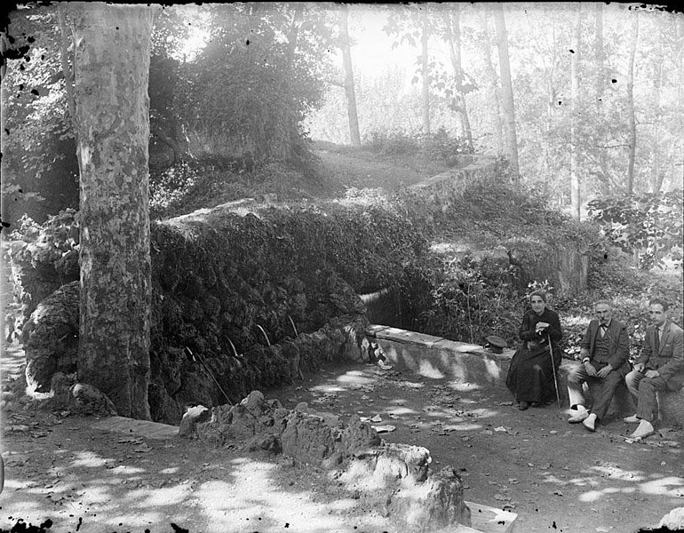 File:Dos homes i una dona asseguts a un mur de pedra enmig del bosc (AFCEC RIBASV C 2633).jpeg