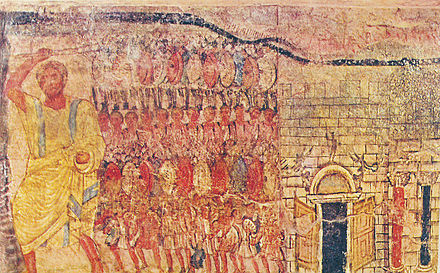Dessin en couleur montrant un homme à la gauche qui domine par sa taille une armée au centre.