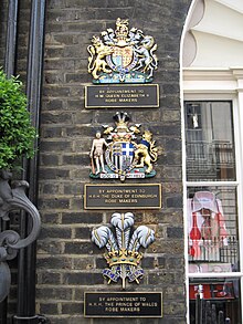 The royal warrants currently held by the company. The coats of arms of Queen Elizabeth II and Prince Philip refer to warrants voided upon their deaths, which may be shown up to two years afterwards . Ede Ravenscroft 3179.JPG