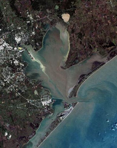 Satellite image of Galveston Bay. Galveston Island is at the bottom of the image, separated from Bolivar Peninsula by Bolivar Roads. A portion of Grea