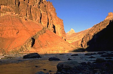 Basalt dike in bright-orange Hakatai Shale along Colorado River at Hance Rapid, river mile 76.5, Grand Canyon. Grand Canyon Supergroup with basalt dike in Hakatai Shale.JPG