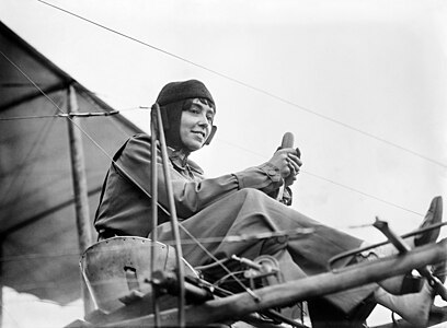 ca. 1911 Aviator Hélène Dutrieu seated in her airplane.