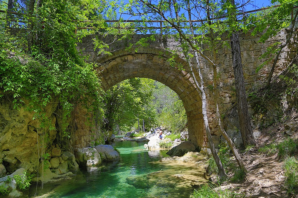 Humpback stone bridge over small river in Cazorla.