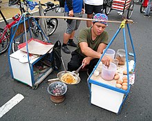 Kerak telor vendor selling spicy coconut omelette, a popular delicacy during Jakarta Fair. Kerak Telor Betawi Vendor.jpg