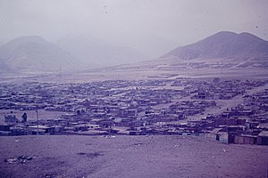 View of shacks in settlement with mountain behind